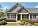 Charming home featuring a well-manicured front yard, black shutters, and a brick entryway, creating a welcoming curb appeal at 1410 Bluestone Dr, Cumming, GA 30041