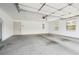 Spacious two car garage featuring an automatic garage door and ample space for storage at 1410 Bluestone Dr, Cumming, GA 30041