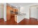 Open-concept kitchen with stainless steel appliances and granite countertops, flowing into the living space at 1410 Bluestone Dr, Cumming, GA 30041