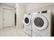 Functional laundry area featuring a modern washer and dryer with overhead storage at 1410 Bluestone Dr, Cumming, GA 30041