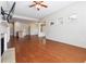 Comfortable living area featuring wood floors, a corner fireplace, and an island countertop in the background at 1410 Bluestone Dr, Cumming, GA 30041