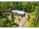 A charming home with a metal roof, nestled amidst mature trees, and complemented by a well-manicured lawn at 1530 Mcbrayer Rd, Temple, GA 30179