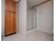 Bathroom features a glass door shower and wood cabinet, complemented by tile flooring at 1530 Mcbrayer Rd, Temple, GA 30179