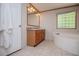Bathroom featuring tile floors, double sink vanity and a corner bathtub at 1530 Mcbrayer Rd, Temple, GA 30179