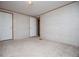 Bedroom featuring neutral carpet, two doors, and an open doorway at 1530 Mcbrayer Rd, Temple, GA 30179