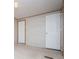 Bedroom with a neutral color palette, two doors, and a large window at 1530 Mcbrayer Rd, Temple, GA 30179