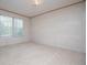 Bedroom features neutral carpet, a large window, and an electrical outlet at 1530 Mcbrayer Rd, Temple, GA 30179