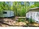 A home and mobile home with an AC unit sit amid verdant landscaping, nestled among towering trees at 1530 Mcbrayer Rd, Temple, GA 30179