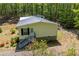 Home featuring siding, blue stairs, and a well-maintained lawn, surrounded by mature trees and natural beauty at 1530 Mcbrayer Rd, Temple, GA 30179