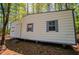 Exterior view of a small building with metal siding and metal roof situated in the woods at 1530 Mcbrayer Rd, Temple, GA 30179