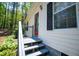 Exterior view of a house with a red front door and a staircase at 1530 Mcbrayer Rd, Temple, GA 30179