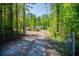 Secluded one-story home nestled back off the road, surrounded by mature trees and colorful plants at 1530 Mcbrayer Rd, Temple, GA 30179