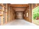 Spacious garage featuring metal walls, sturdy wooden beams and concrete flooring, providing ample space for vehicles and storage at 1530 Mcbrayer Rd, Temple, GA 30179