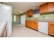 Bright kitchen with wood cabinets, a white refrigerator, and an adjacent dining area at 1530 Mcbrayer Rd, Temple, GA 30179