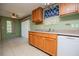 This eat-in kitchen has wood cabinets, stainless steel double sink, and green walls at 1530 Mcbrayer Rd, Temple, GA 30179