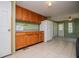 Eat-in kitchen featuring wood cabinets, countertops, white appliances, and tiled floors at 1530 Mcbrayer Rd, Temple, GA 30179