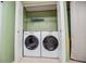 Laundry room with a stacked washer and dryer and wire shelving above at 1530 Mcbrayer Rd, Temple, GA 30179