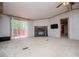 Spacious living room featuring a stone fireplace, ceiling fan, and sliding door leading to an outdoor deck at 1530 Mcbrayer Rd, Temple, GA 30179
