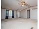 Inviting living room with large window, ceiling fan, and neutral carpet providing a comfortable living space at 1530 Mcbrayer Rd, Temple, GA 30179