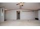 Open concept living area with ceiling fan, neutral walls, and access to multiple rooms creating a spacious feel at 1530 Mcbrayer Rd, Temple, GA 30179
