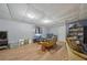 Finished basement area with vinyl floors, a comfortable sofa, and entertainment center at 165 Holly Ct, Loganville, GA 30052