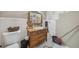 Bathroom featuring a pedestal sink, a toilet, and an antique-style vanity at 165 Holly Ct, Loganville, GA 30052