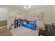 Bright bedroom featuring a large window, wood floors, and a comfortable bed at 165 Holly Ct, Loganville, GA 30052