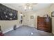 Bedroom featuring carpet, neutral paint, ceiling fan, and a large wooden dresser at 165 Holly Ct, Loganville, GA 30052