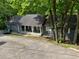 Charming single-story home with a covered front porch and mature trees at 165 Holly Ct, Loganville, GA 30052
