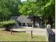 Cozy home with a covered porch, nestled among trees at 165 Holly Ct, Loganville, GA 30052