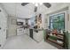 Bright kitchen features white appliances and cabinets, tile flooring and a ceiling fan at 165 Holly Ct, Loganville, GA 30052
