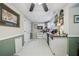 Bright kitchen features white appliances and cabinets, tile flooring and a ceiling fan at 165 Holly Ct, Loganville, GA 30052