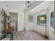 Sun room featuring wood floors and plenty of natural light, along with a doorway to laundry room at 165 Holly Ct, Loganville, GA 30052
