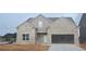 Charming single-story brick home featuring a two-car garage and inviting entrance at 3708 Southfield Ct, Loganville, GA 30052