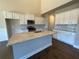 Bright kitchen featuring granite countertops, stainless steel appliances, and white cabinetry at 3708 Southfield Ct, Loganville, GA 30052