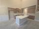 A new kitchen featuring light wood cabinetry, a kitchen island, and white countertops at 3708 Southfield Ct, Loganville, GA 30052