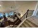 A view from the staircase overlooking the living room with a fireplace and abundant natural light at 3708 Southfield Ct, Loganville, GA 30052