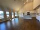 Open-concept living room and kitchen with wood floors, abundant natural light, and white cabinetry at 3708 Southfield Ct, Loganville, GA 30052