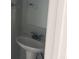 Powder room with pedestal sink, mirror, and new fixtures at 4817 Hidden Creek Place, Decatur, GA 30035