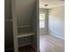 Bedroom features built-in desk, neutral paint, wood-look flooring, and natural light at 4817 Hidden Creek Place, Decatur, GA 30035