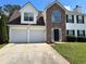 Charming two-story home with a two-car garage and a stone facade, set on a sunny lot at 4817 Hidden Creek Place, Decatur, GA 30035