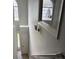 Bright hallway featuring a window, light fixture, and doors at 4817 Hidden Creek Place, Decatur, GA 30035