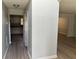 Hallway with neutral walls, vinyl flooring, and doors to the kitchen and living room at 4817 Hidden Creek Place, Decatur, GA 30035