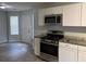 Modern kitchen with stainless steel appliances and new floors at 4817 Hidden Creek Place, Decatur, GA 30035