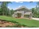 Spacious backyard featuring a lush lawn and two-story home at 1005 Liberty Springs Dr, Woodstock, GA 30188