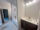 Well-lit bathroom with a vanity, sink, and bathtub with tiled shower at 1005 Liberty Springs Dr, Woodstock, GA 30188