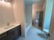 Bright bathroom featuring a single sink vanity with quartz countertops and a combined tub and shower at 1005 Liberty Springs Dr, Woodstock, GA 30188
