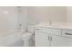 Bathroom with white cabinetry, a quartz countertop, a tub with shower, and a toilet at 1005 Liberty Springs Dr, Woodstock, GA 30188
