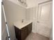 Bathroom vanity featuring white countertop and dark wood cabinets at 1005 Liberty Springs Dr, Woodstock, GA 30188