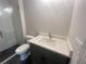 Modern bathroom featuring a glass shower, black herringbone tile, white countertop vanity, and contemporary fixtures at 1005 Liberty Springs Dr, Woodstock, GA 30188
